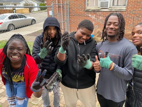 Youth volunteers showing off their freshly composted soil at the Knox County Community Garden & Growers Alliance.