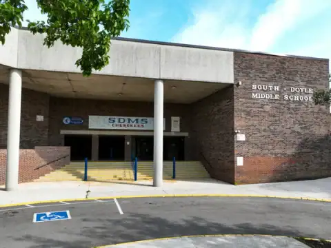 Exterior view of Cedar Bluff Middle School, showcasing the main entrance with signage, steps, and accessible parking, located in Knox County.