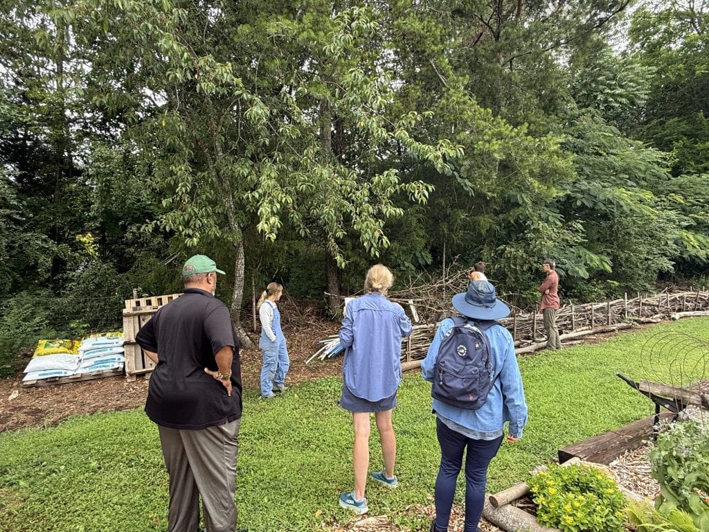 Group of people attending a community garden meeting in Knox County, discussing garden plans and sustainable practices.