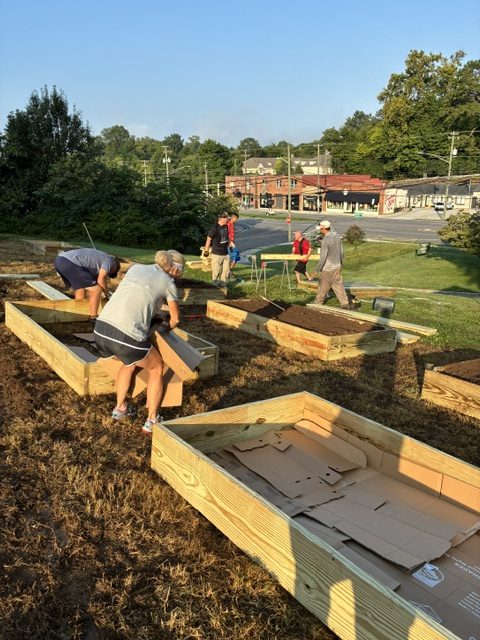 Volunteers building raised garden beds at Knox County community garden to promote local food security and community engagement.