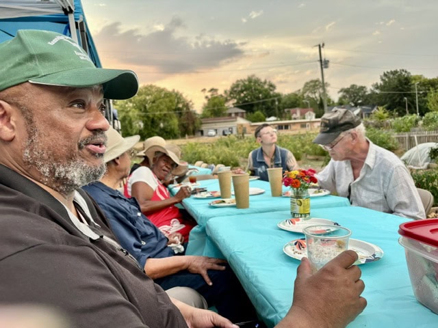 Community members enjoying a meal at the Knox County Community Garden dinner event, highlighting local food and community engagement.